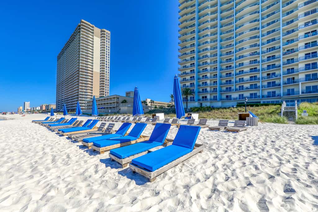Chairs lined up on a beach for Sterling Breeze Beach Resort guests.