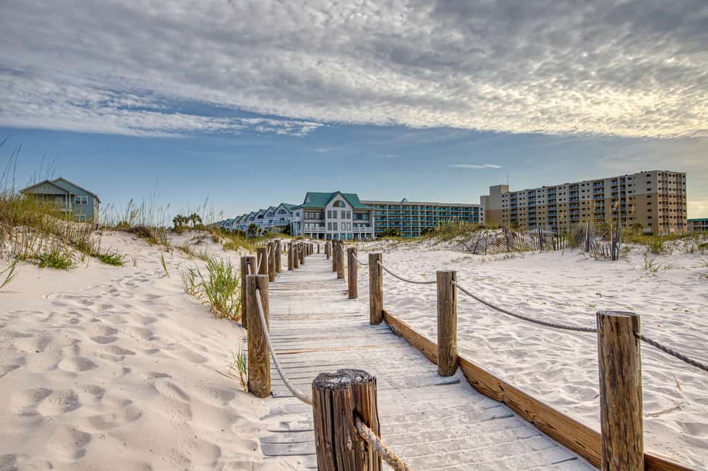 The view from the boardwalk beach access of hotels and vacation rentals in Gulf Shores, AL.