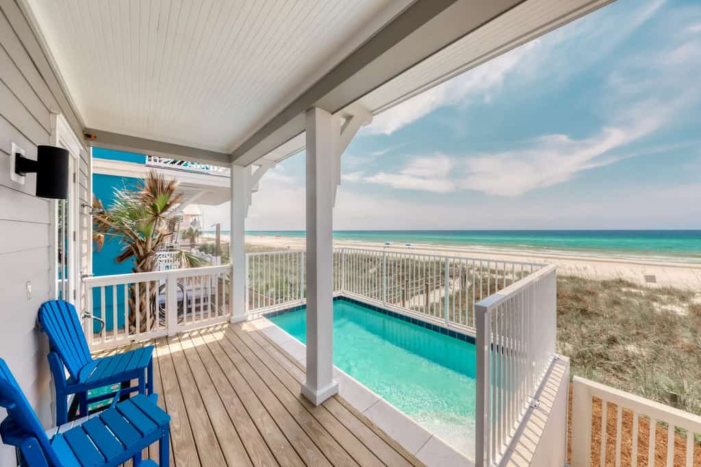 patio of vacation condo facing the ocean with a pool