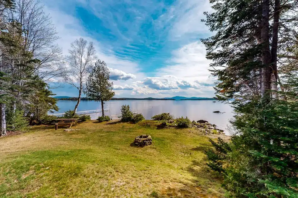 vacation rental backyard with firepit and waterfront access