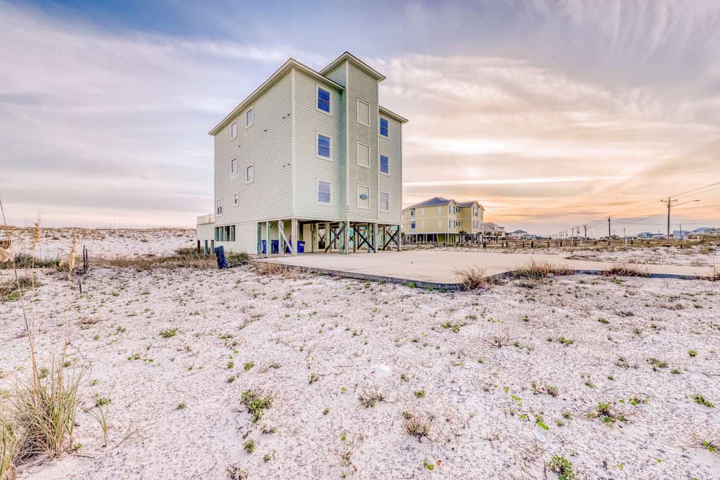 The back of a vacation rental with deck in Gulf Shores, AL.