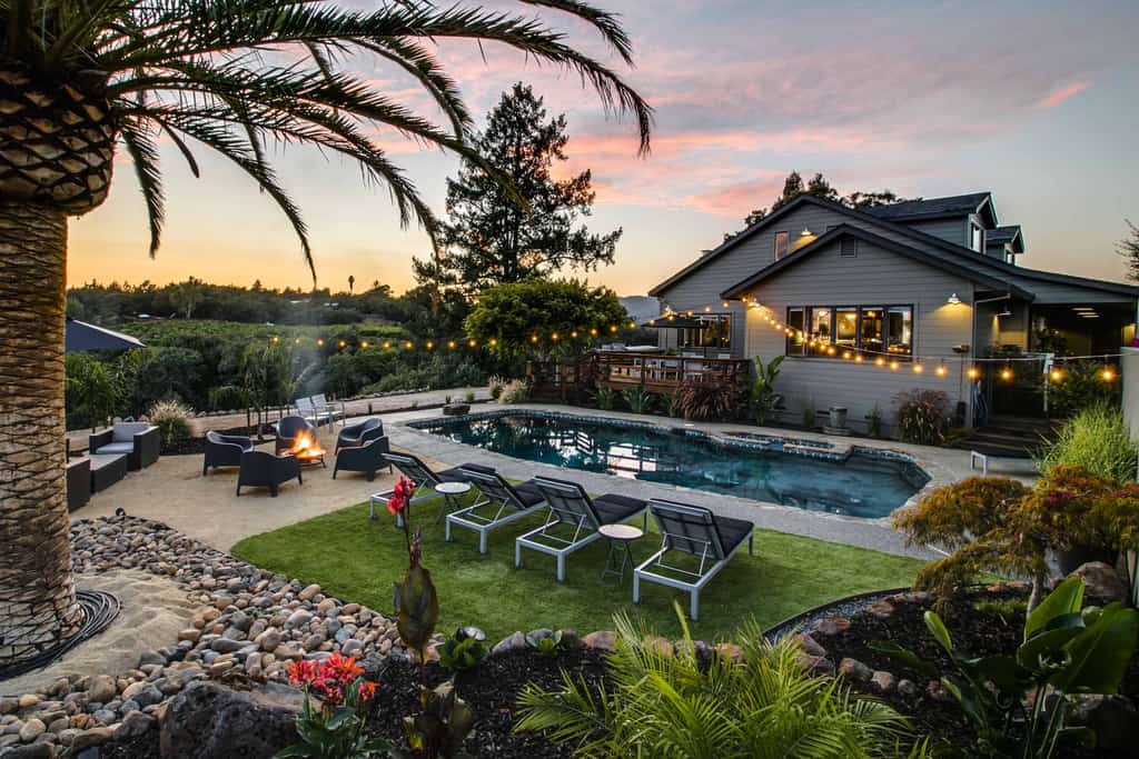 A pool and lawn outside of a California vacation home