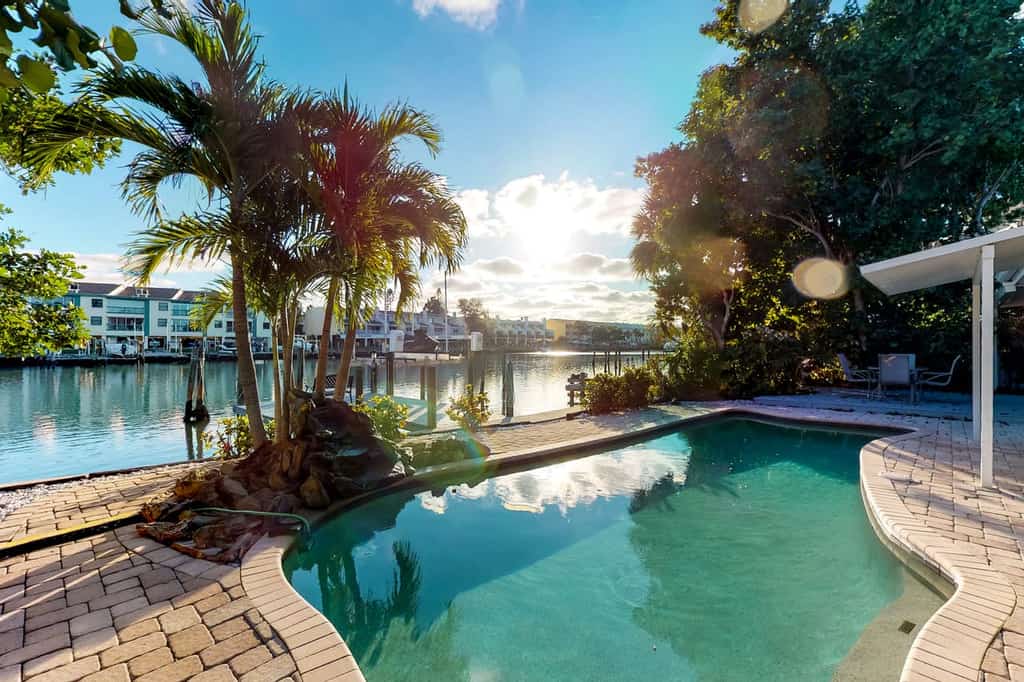 An outdoor pool at a vacation rental in Tampa Bay, FL near the bay.