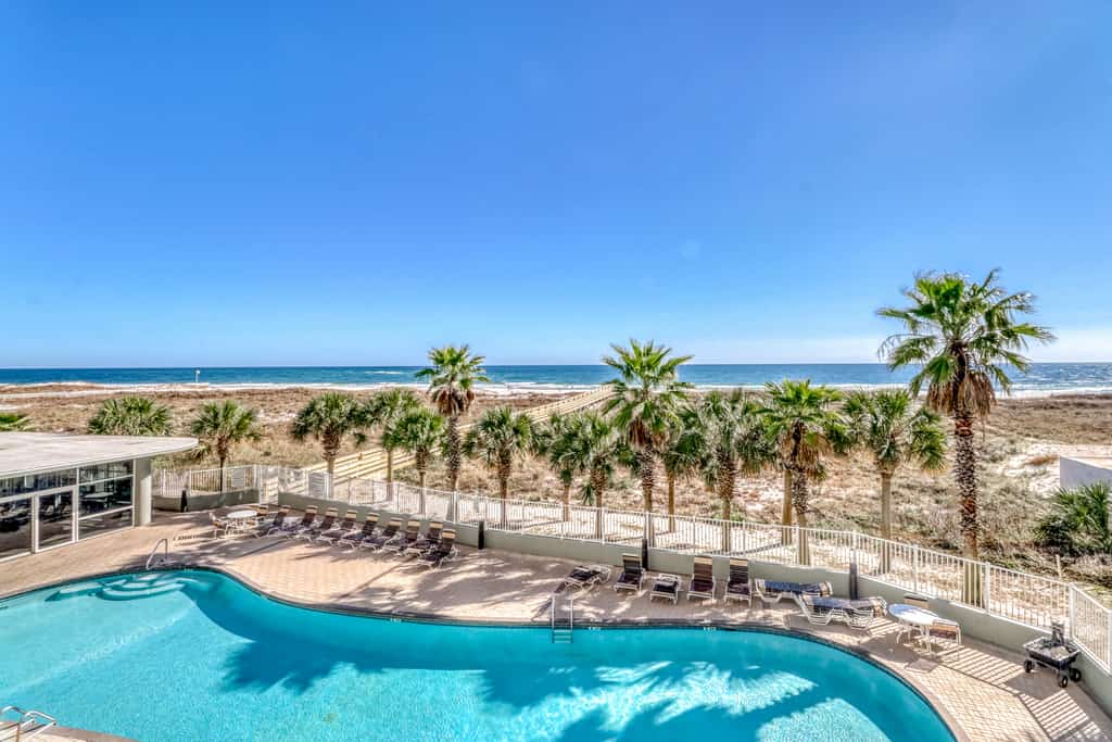 The pool area with the coastline in the foreground at Tidewater Beach in Orange Beach.