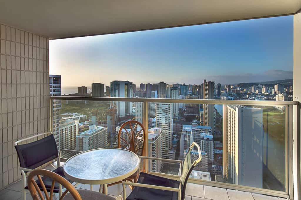 Condo rental balcony in Honolulu overlooking the skyline