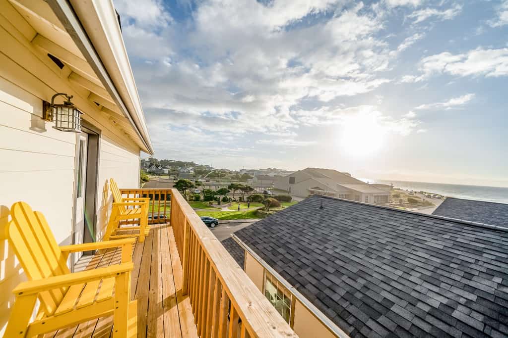 The back deck of a vacation rental overlooking the ocean in Newport, OR.
