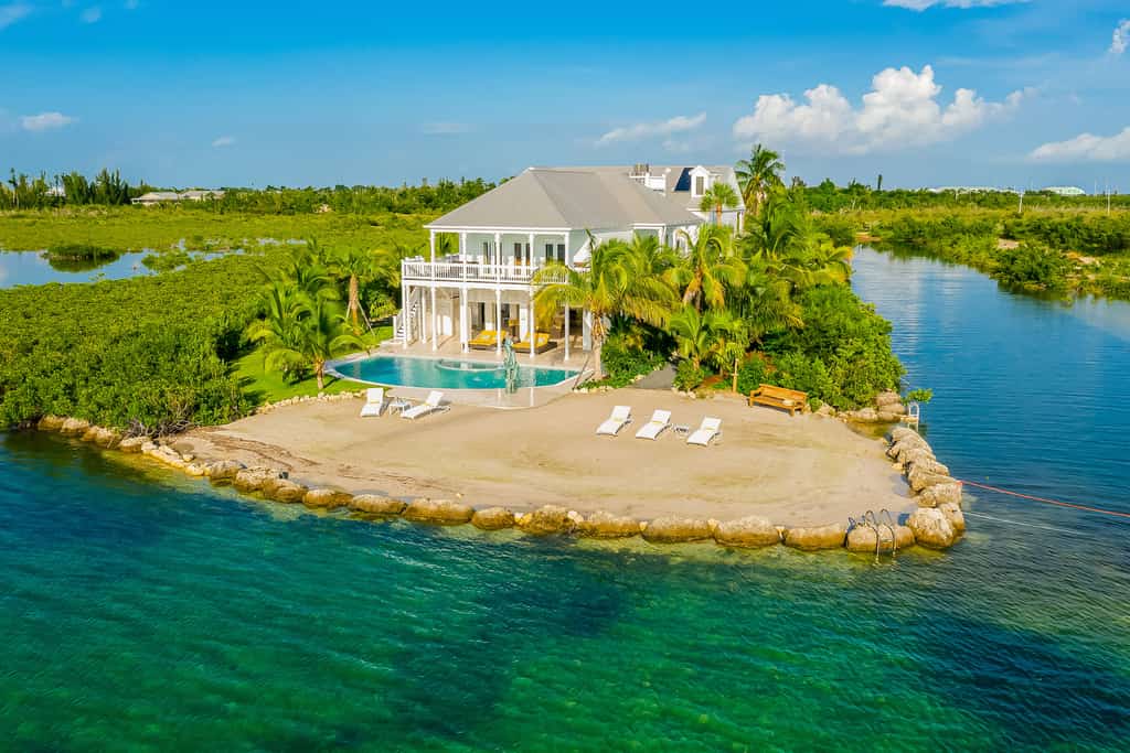 waterfront vacation rental with pool and lounge chairs in sugarloaf key