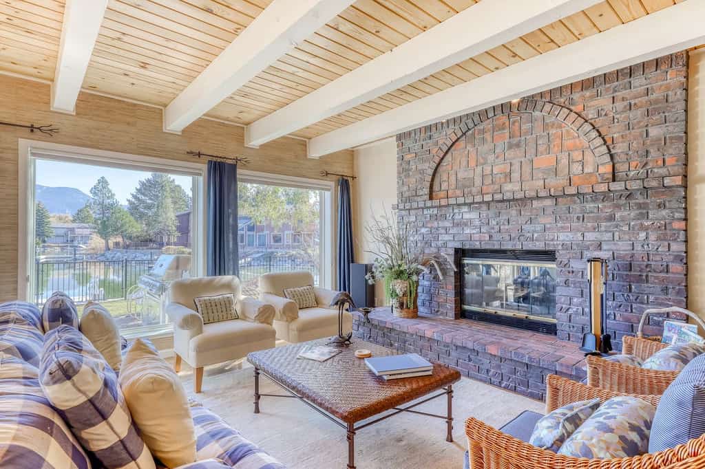 Large stone indoor fire place in a furnished living room in South Lake Tahoe, CA