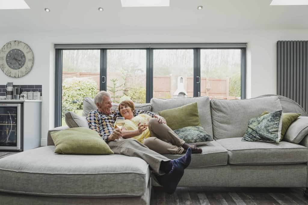 A couple on a couch enjoying a glass of wine