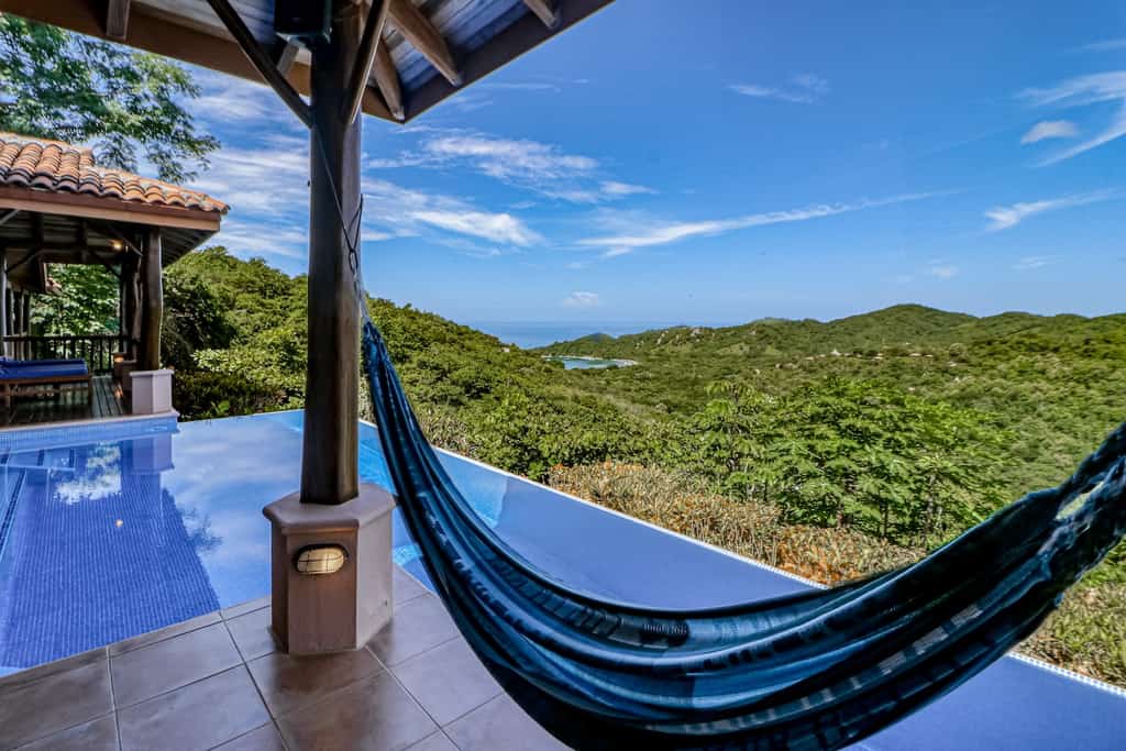 Pool and hammock overlook the jungle.
