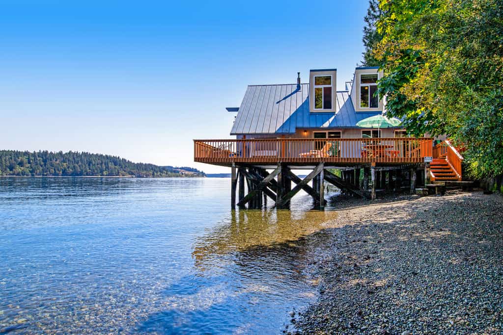 Lakefront vacation home with a patio overlooking the water.