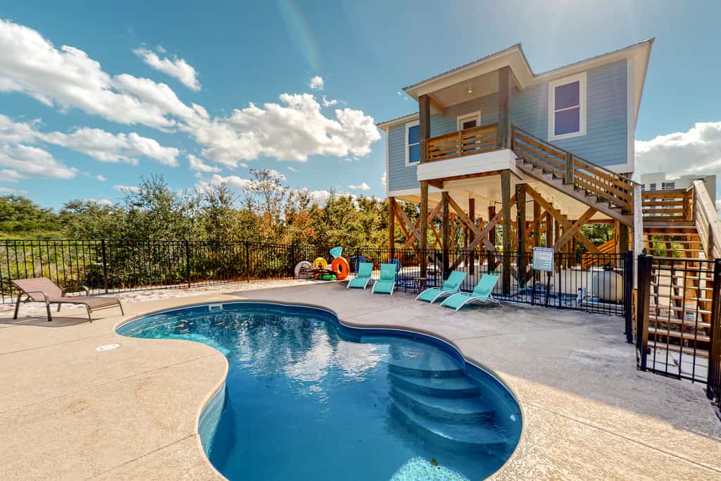 The back pool area of a vacation rental in Orange Beach, AL.