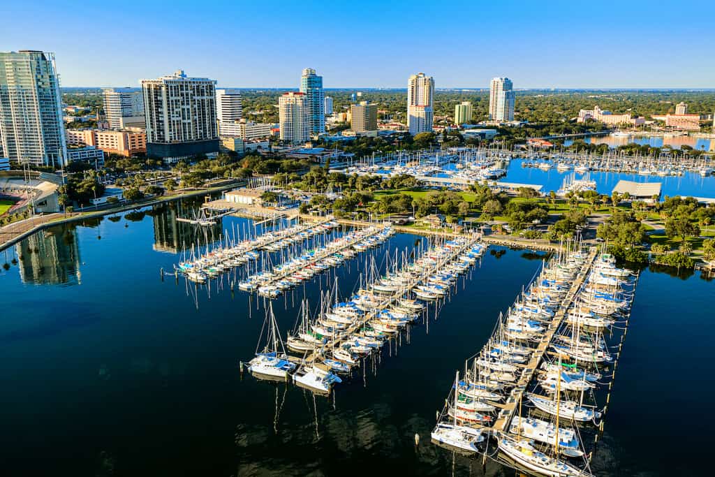 Drone shot of a marina lined with boats and the city of St. Pete Beach.
