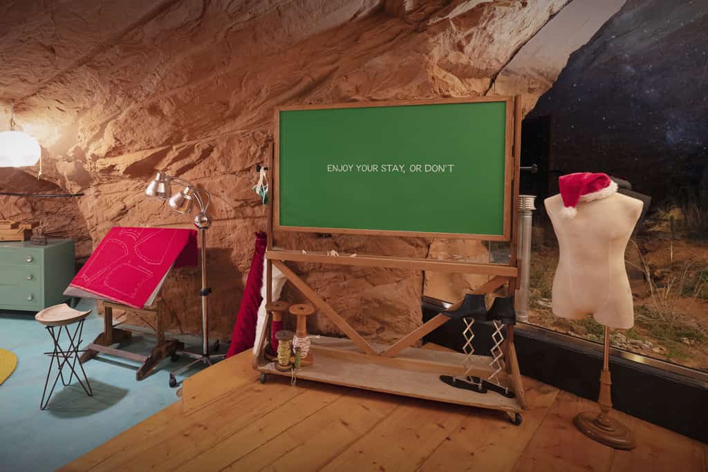 chalkboard that says "enjoy your stay, or don't" inside the grinch's cave