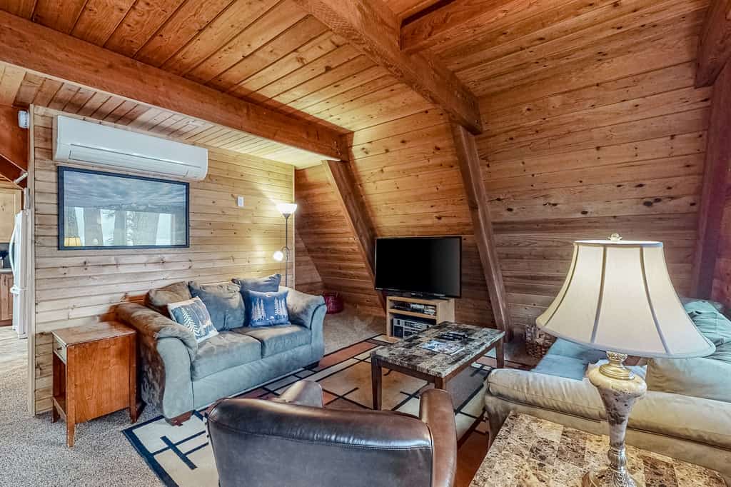 The interior of a vacation rental cabin with rustic design on Wallowa Lake.