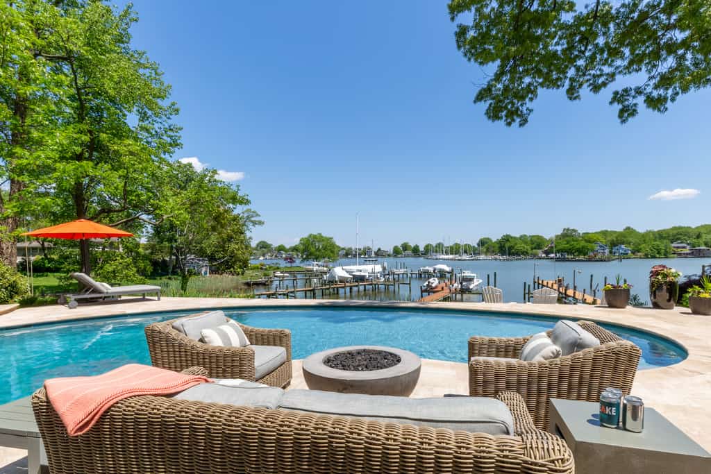 The view from the back patio of a vacation rental in Annapolis with a pool that overlooks the marina and the lake.
