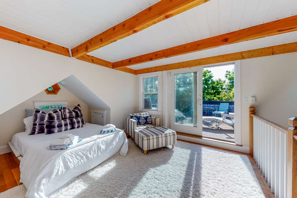 The bedroom of a vacation rental in Martha's Vineyard with a patio.