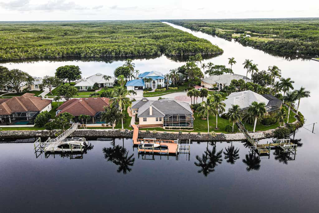 Drone shot of a vacation rental with a dock on the water in Naples, Florida.