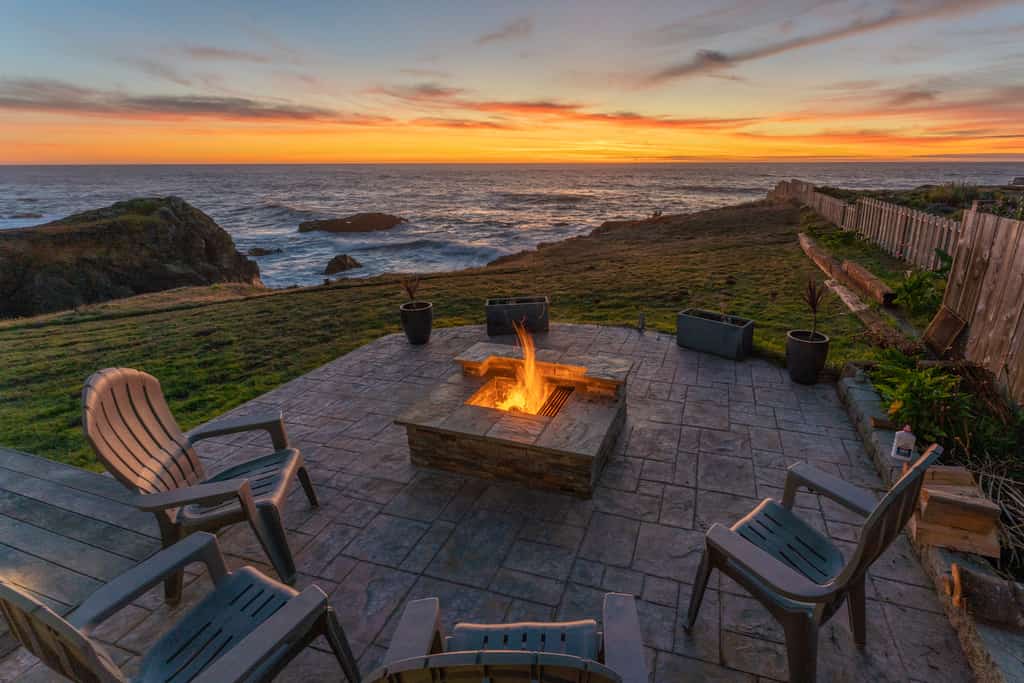 The fire area overlooking a the ocean during sunset at a Fort Bragg vacation rental.