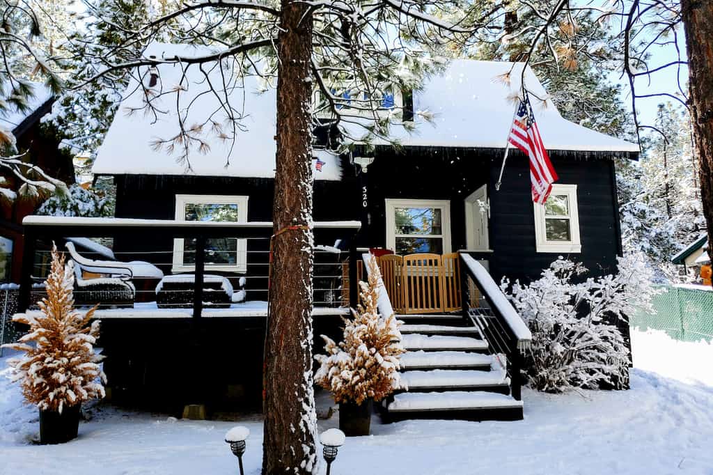 The exterior of a home covered in snow at a Big Bear, CA cabin rental.