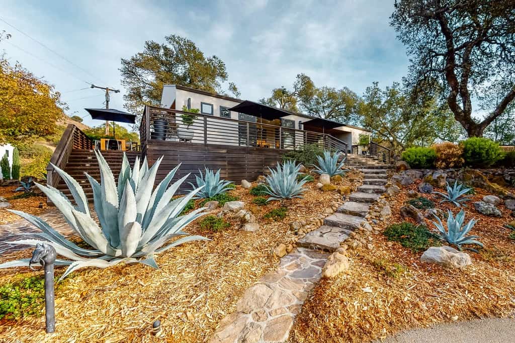 Vacation rental home in Sonoma, CA with a wooden patio and sun umbrellas.