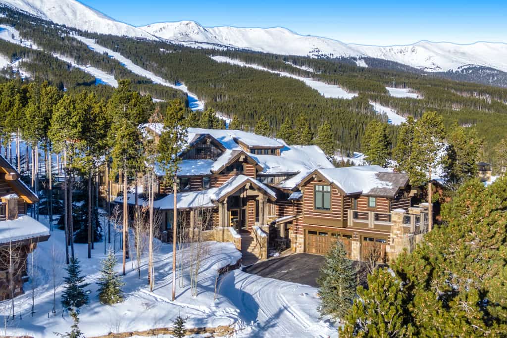 large ski in ski out home in breckenridge surrounded by trees and snow