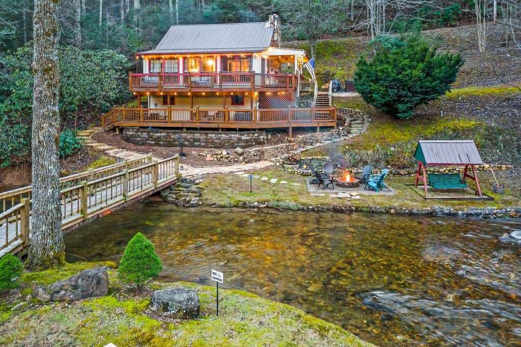 Vacation rental on the river with a backyard and bridge.