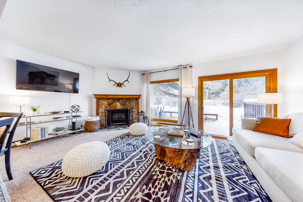 Indoor stone fire place in a living room at a vacation home in Jackson, WY