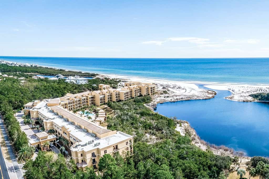 A condominium complex in Santa Rosa Beach, FL by the ocean with an inlet to a bay.