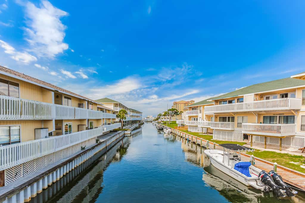 The canal between two lodging solutions leading to the ocean.