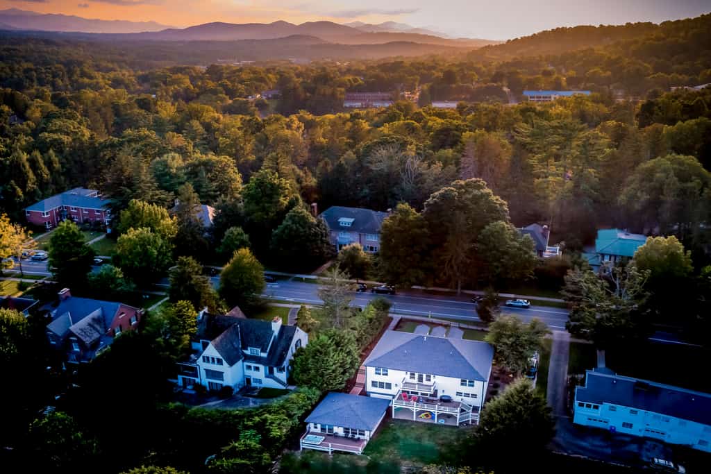 homes scattered throughout asheville with mountains in the background at sunset