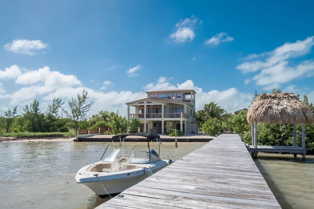 A vacation home with a private boat dock and a boat in Belize