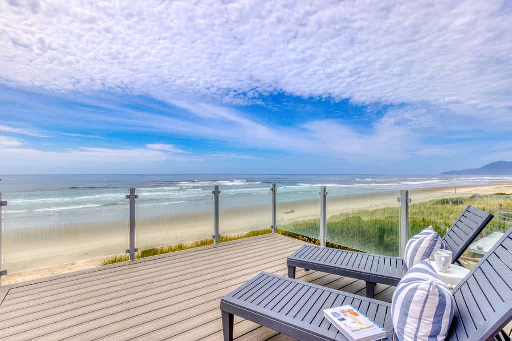 two chaise lounge chairs face the pacific ocean in rockaway beach