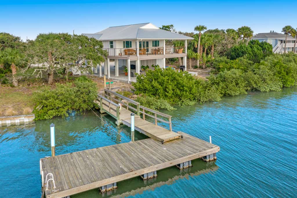 two story home with wraparound deck and private dock access
