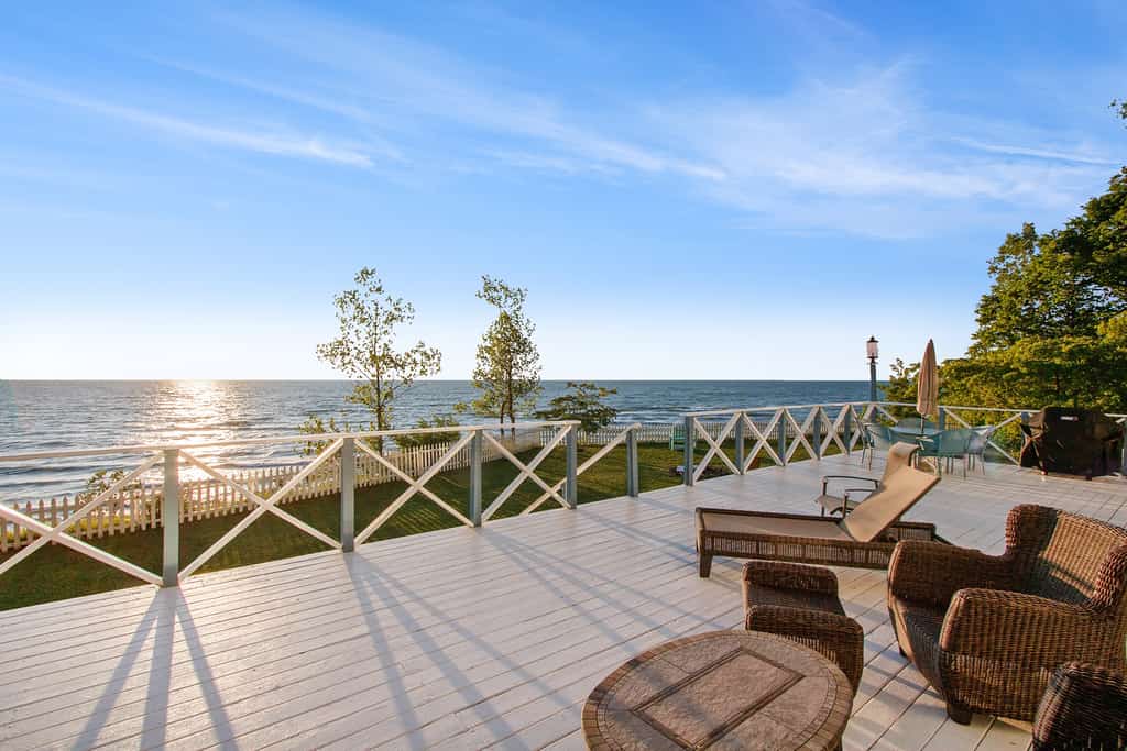back deck of lakefront vacation home overlooking lake michigan at sunset