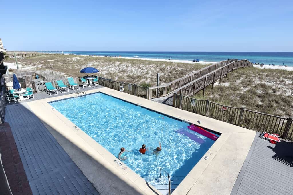 People in a pool overlooking the Florida Gulf Coast.
