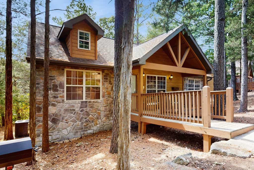 a stone cabin in a wooded setting