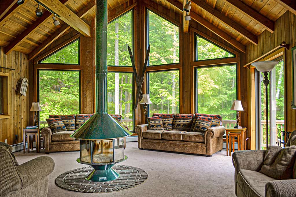 Wood cabin living room with a wood burning stove in Ludlow, VT