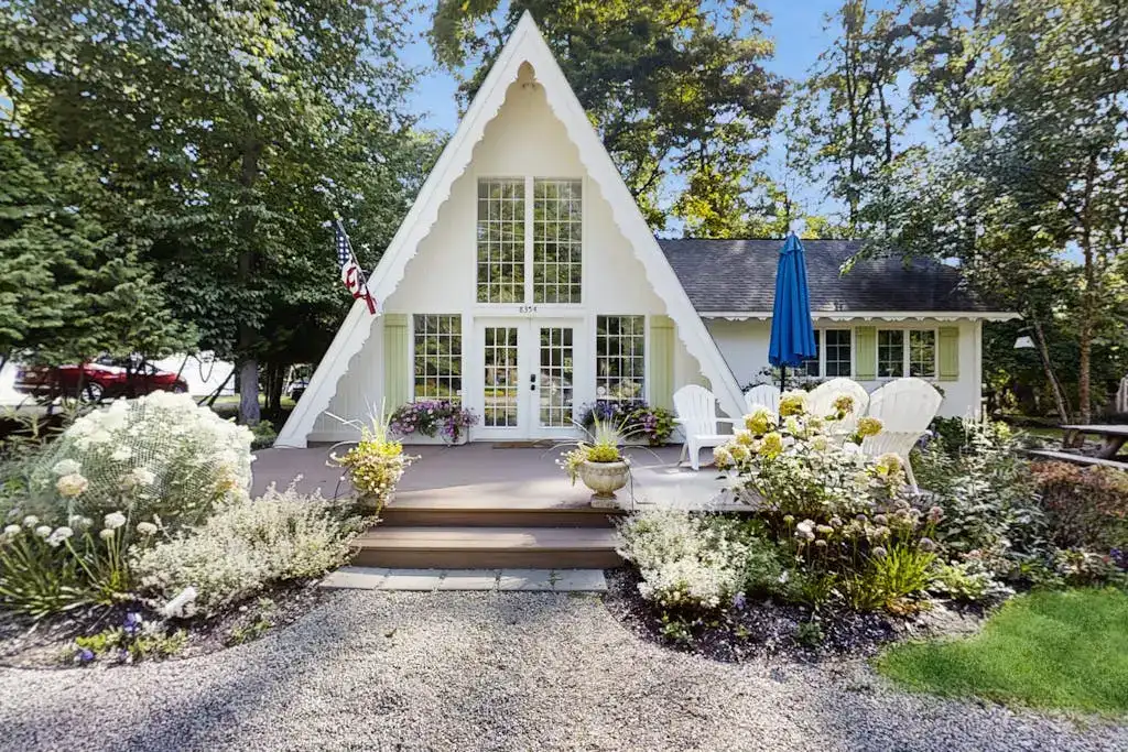 front exterior of a white A-frame cabin