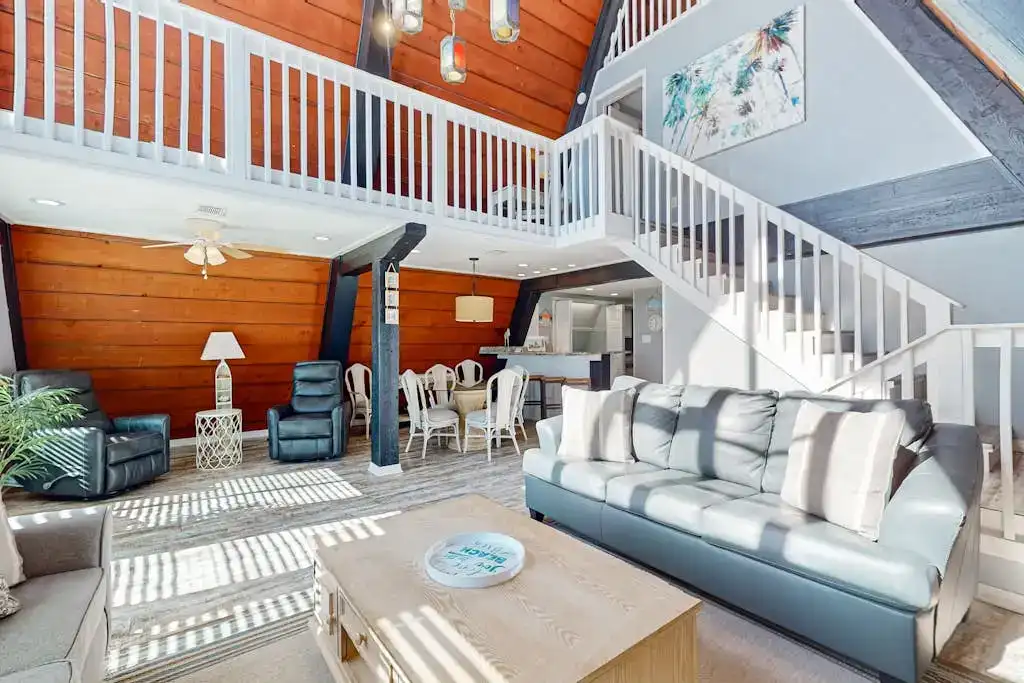 vacation rental living room with white staircase