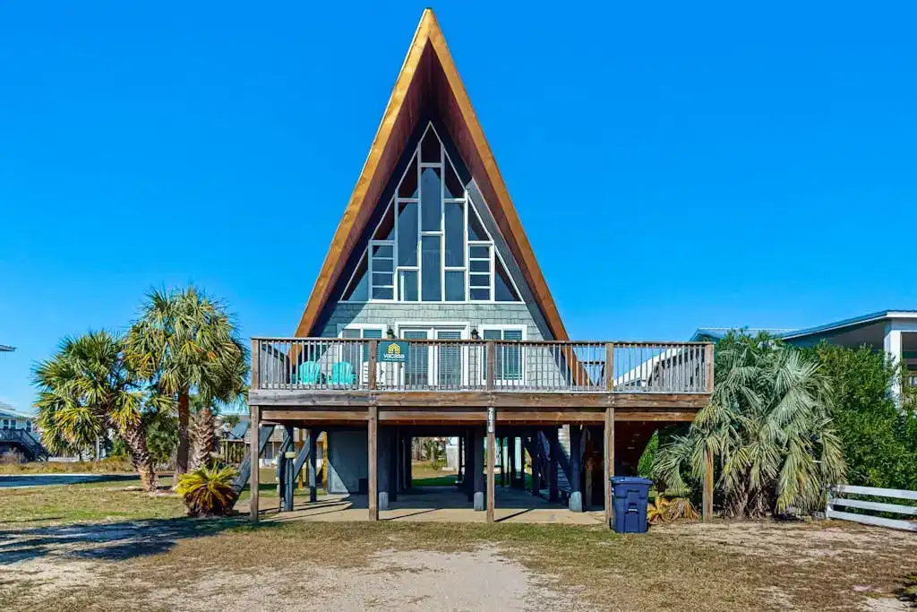 exterior of A-frame cabin with stilt style foundation