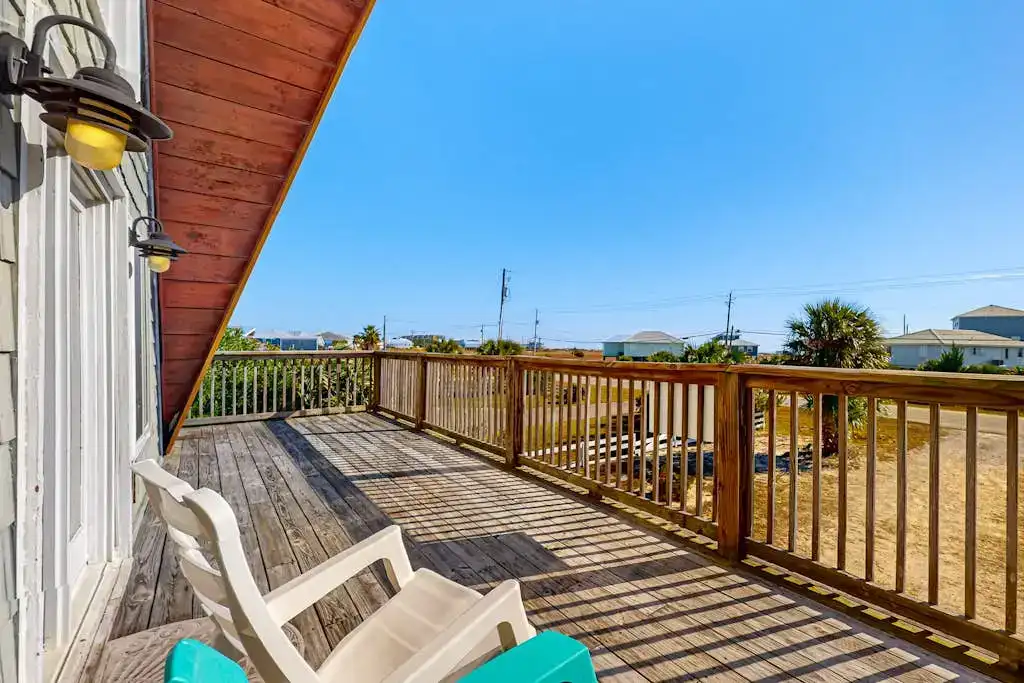 wooden deck of a vacation rental overlooking driveway