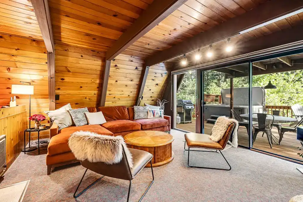 cabin living room with exposed beams and chic furniture