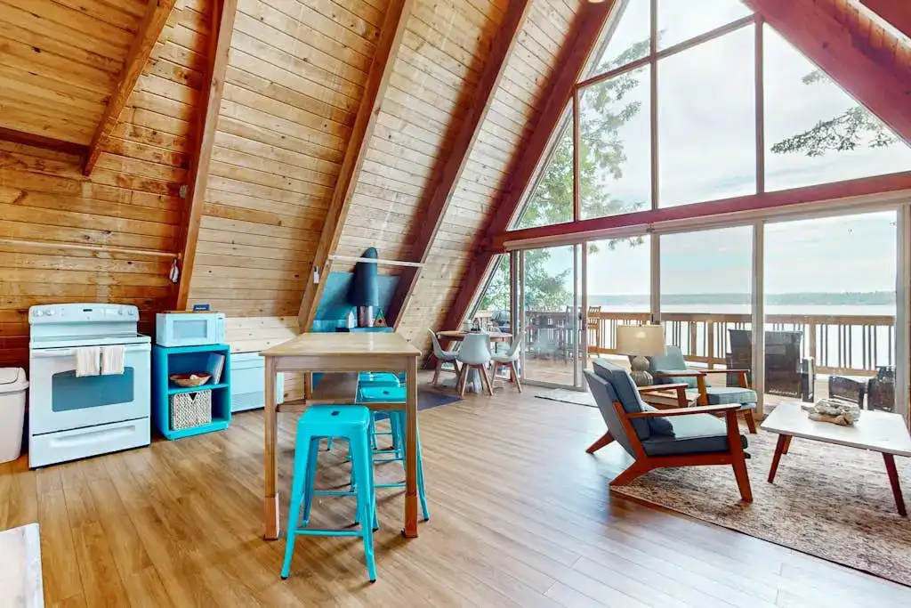 living room of A-frame cabin with floor to ceiling windows