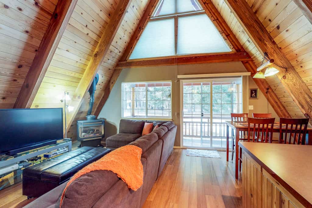 The interior living area of an A-Frame cabin rental in Lake Tahoe, CA.