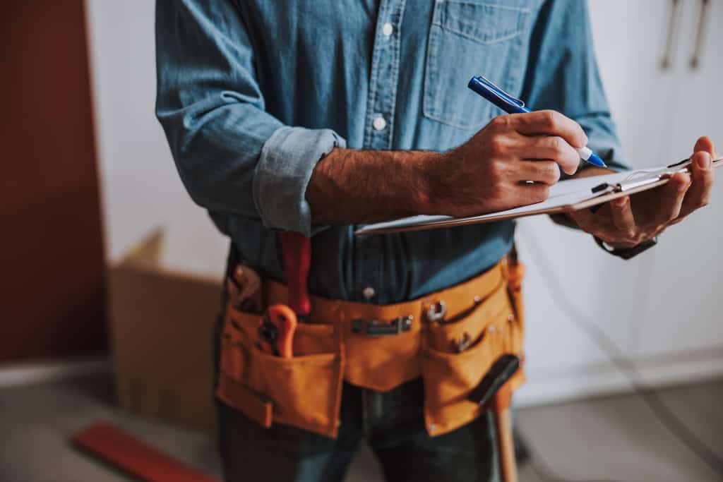 maintenance worker fills out paperwork