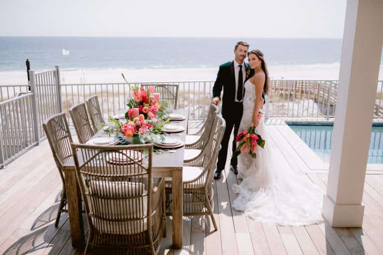 bride and groom pose for wedding pictures at their Alabama Gulf Coast wedding-friendly vacation rental