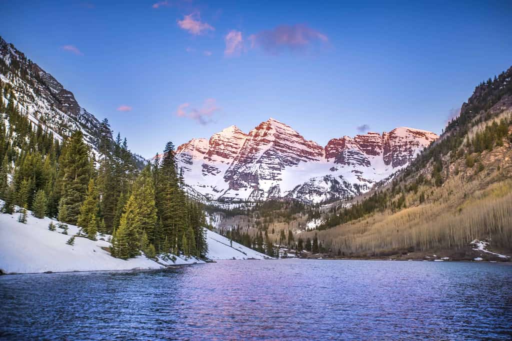 A lake with a view of snowy mountains in Aspen, CO.