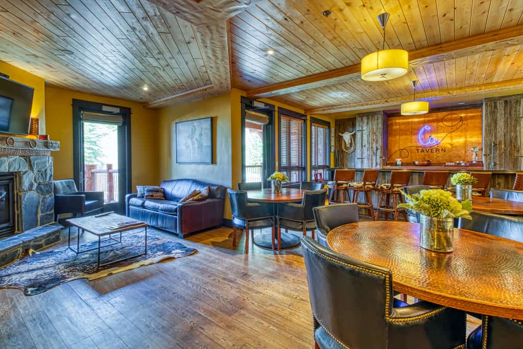 BlueSky Breckenridge tavern with a fireplace, bar and a cabin style designs.