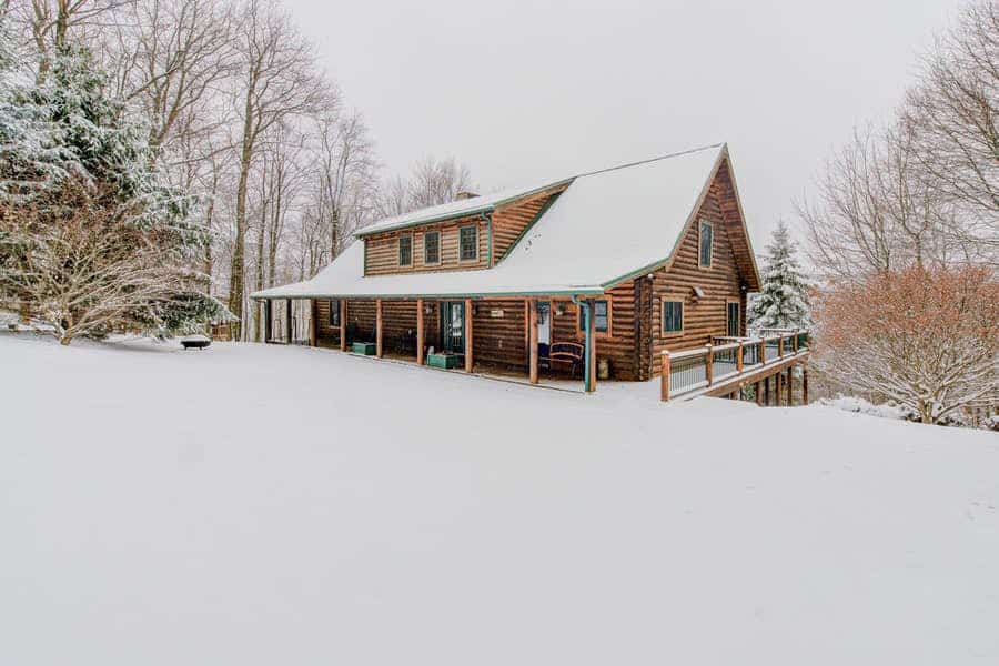 log cabin near deep creek lake covered in snow